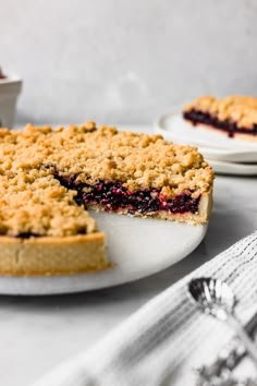 a blueberry crumb pie on a white plate