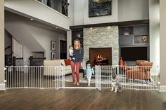 a woman and two children in a living room with a dog on the floor next to them