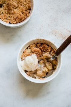 two bowls filled with food on top of a table