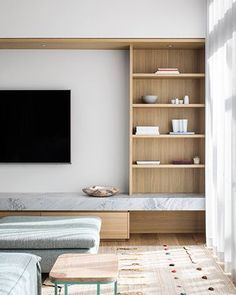 a living room filled with furniture and a flat screen tv