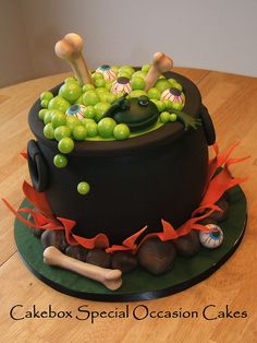 there is a cake that looks like a caulder with green grapes in it