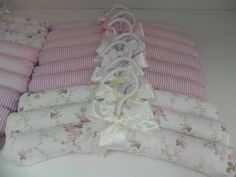 pink and white bedding laid out on top of each other