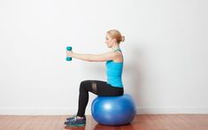 a woman is sitting on an exercise ball and holding a dumbble with one arm