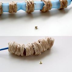 a blue toothbrush with some string attached to it on a white table next to other items