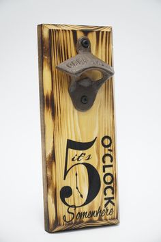 a bottle opener with the number five on it's side and an old fashioned clock