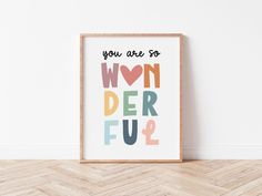 a framed poster with the words you are so won der ful in multicolored letters