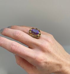 Vintage Ornate Amethyst Cocktail Ring in 14k Yellow Gold Era: Vintage, Mid Century 1940's Condition: Excellent Materials 14k Yellow Gold, Large Oval Center Stone Measuring approx .5 inches long by .25 inches wide Heirloom 14k Stamped Amethyst Jewelry, Heirloom Amethyst Ring In 14k Gold, Heirloom 14k Gold Amethyst Ring, Heirloom 14k Gold Amethyst Ring With Accent Stones, Purple 14k Stamped Collectible Jewelry, Antique Oval Amethyst Multi-stone Ring, Vintage 14k Gold Multi-stone Amethyst Ring, Vintage Multi-stone Amethyst Ring In 14k Gold, Victorian Yellow Gold Amethyst Gemstone Ring