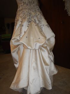 a wedding dress on display in a room