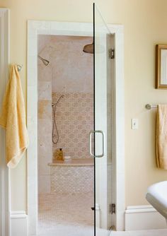 a bath room with a stand up shower next to a sink and a mirror on the wall