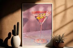 a painting of a martini glass sitting on top of a table next to a potted plant