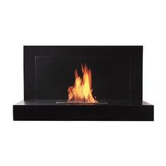 a fire burning inside of a glass case on top of a black shelf with flames in it