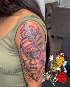 a woman with a butterfly tattoo on her arm and shoulder is looking at the camera