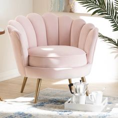 a pink chair sitting on top of a rug