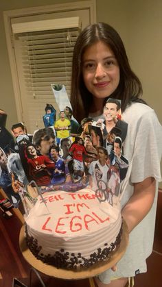 a woman holding a cake with pictures on it