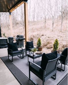 an outdoor patio with black furniture and grill