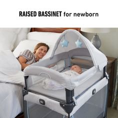 a woman laying in bed next to a baby's crib with the words raised bassinet for newborn