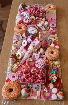 an assortment of donuts and candy on a table