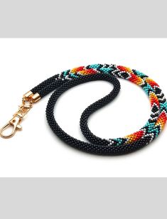 a multicolored beaded dog leash on a white background