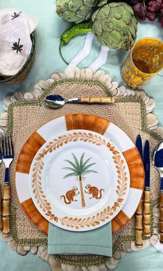 a place setting with plates, silverware and napkins