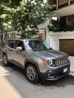 the jeep is parked on the side of the street