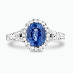 Just as the sun’s rays radiate outward, casting light in every direction, so too does this Split Shank Blue Sapphire Engagement Ring with Diamond Halo. Its airy castle-set diamond pavé and split shank lend this meaningful token of love, a vintage appeal. Centre blue sapphire pictured: Oval, 7x5 mm approx Accent diamonds: 0.10+ ctw, VS2+/F+ Setting: Castle-setting Band width: 2.2 mm approx. (each accent diamond is 1.2-1.8 mm approx.) Timeless Blue Diamond Ring With Halo Setting, Oval Blue Diamond Ring With Pave Setting, Blue Sapphire Ring With Pave Diamond Setting, Blue Sapphire Diamond Ring With Pave Setting, Blue Diamond Ring With Pave Setting, Luxury Lab-created Sapphire Diamond Ring With Halo Setting, Luxury Diamond Ring With Lab-created Sapphire In Halo Setting, Split Shank Sapphire Ring, Luxury Blue Lab-created Sapphire Halo Ring