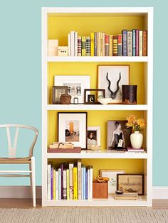 a bookshelf filled with lots of books and pictures