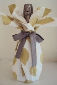 a bottle wrapped in fabric with a bow