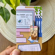 a person holding up a card with a drink on it