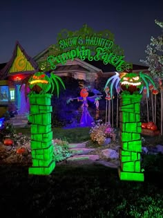 an entrance to a halloween themed house at night with decorations on the front and side