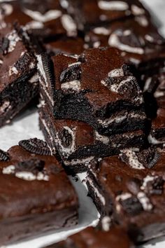 chocolate brownies with oreo cookies and white sprinkles are stacked on top of each other