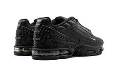 The Nike Air Max Plus 3 “Triple Black” is a stealthy colorway of the throwback Nike shoe made popular in rave culture in the late 1990s and early 2000s.  The highly versatile Air Max Plus 3 “Triple Black” dons a lightweight yet durable gradient mesh upper that begins with a light grey hue on the toe and progressively darkens around the forefoot and mid-panel.  Black leather overlays appear throughout the upper and contrast the look.  The padded ankle collar features soft black leather while the Triple Black Shoes, Nike Air Max Plus 3, Rave Culture, Nike Shoe, Stadium Goods, Nike Air Max Plus, Air Max Plus, Triple Black, Early 2000s