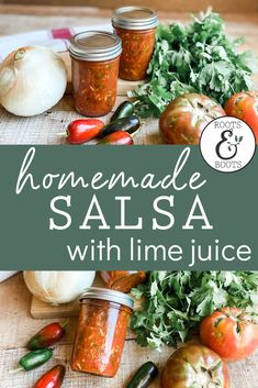 homemade salsa with lime juice in jars on a cutting board surrounded by fresh vegetables and herbs