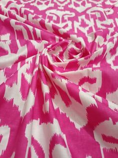 a pink and white fabric with an abstract design