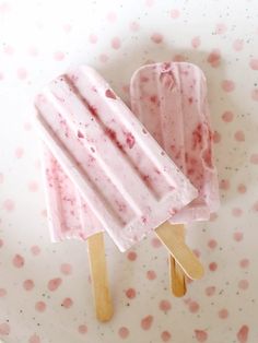 two popsicles on a white plate with pink polka dots