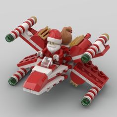 a red and white lego airplane with santa clause on it