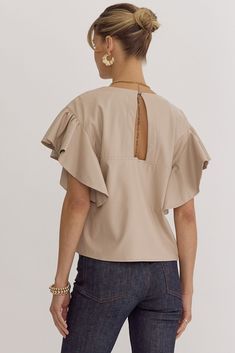 Indulge in luxury with our Sofie Soft Vegan Top. Crafted from supple vegan leather in the season's best neutral, ecru. Waterfall styled sleeves and a v-neckline with cut out and button closure at the back add a touch of sophistication. Unlined for maximum comfort and style. Faux Leather Top, Toddler Pajamas, Bib Set, Bootie Sandals, Cutout Design, Cropped Flares, Top Graphic Tees, Short Sleeve Bodysuit, Neck Ruffle