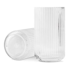 two clear glass vases sitting next to each other on a white surface with the lid open