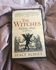 the witches salem, 1062 a history by staychiff on top of a bed