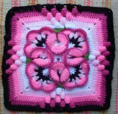 a pink and black square with flowers on it