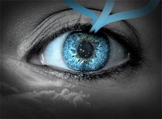 an eye with blue iris and white clouds in the background