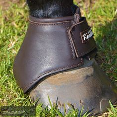 a horse's shoe with a leather cover on top of it in the grass