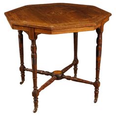 an octagonal wooden table with turned legs