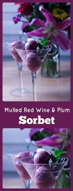 two martini glasses filled with red wine and plum sorbet garnished with fresh flowers