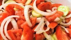 a white bowl filled with vegetables and onions