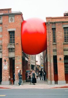 a large red object in the middle of a street