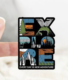 a hand holding up a sticker with the letter k is for fox every day is new adventure