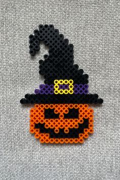 a beaded pumpkin with a witch hat on it