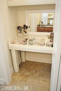 there is a vanity in the bathroom with its mirror and makeup products on it's shelf