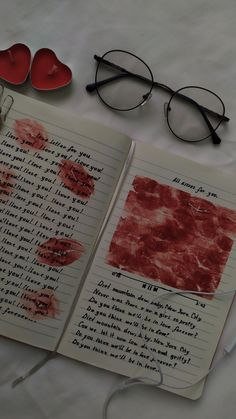 an open notebook with writing on it next to eyeglasses and a pair of heart shaped glasses