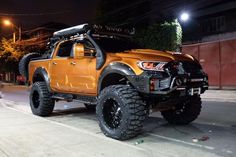 an orange truck parked on the street at night